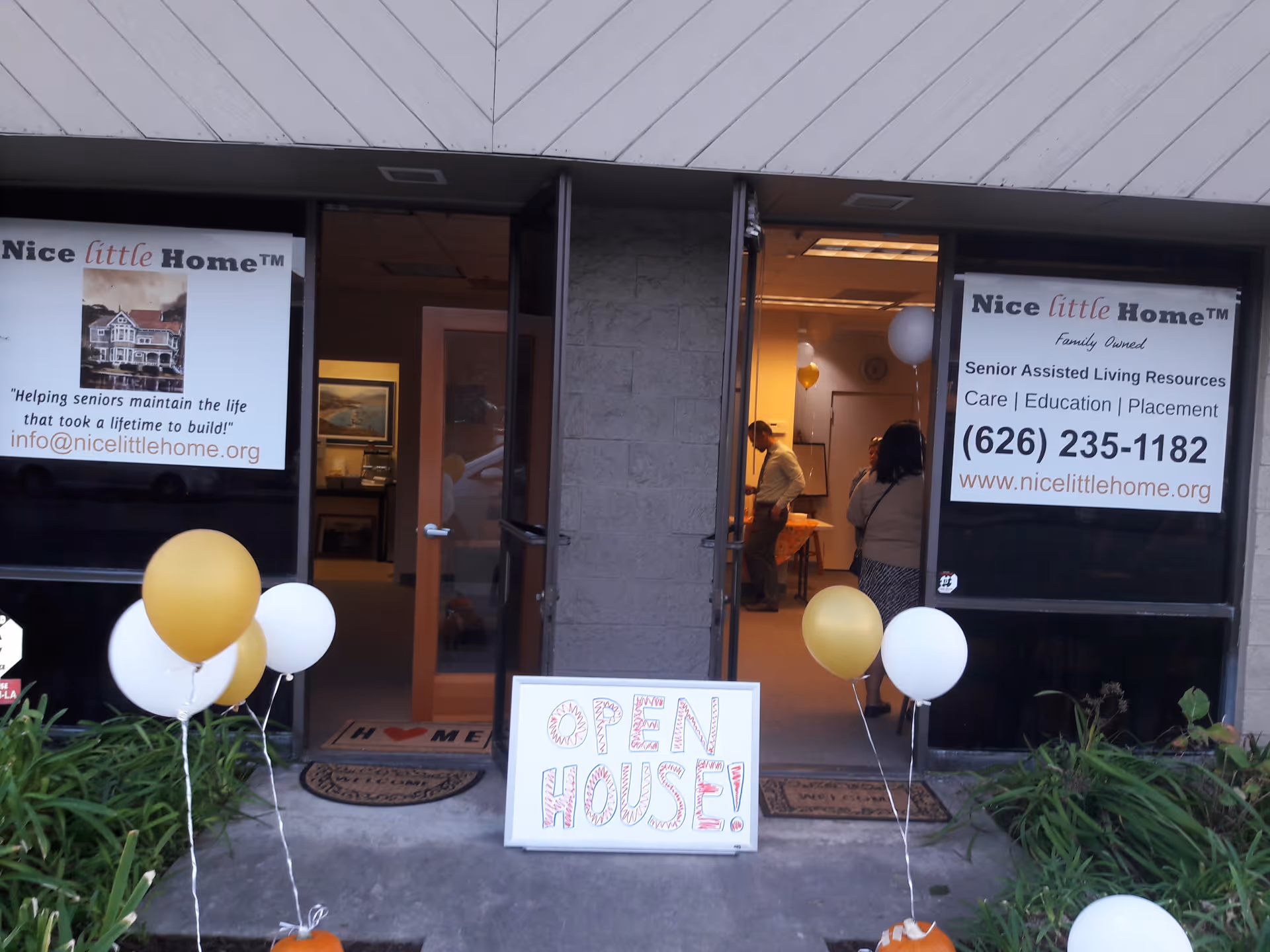 Front entrance of Nice little Home with open doors, balloons, and an Open House sign.