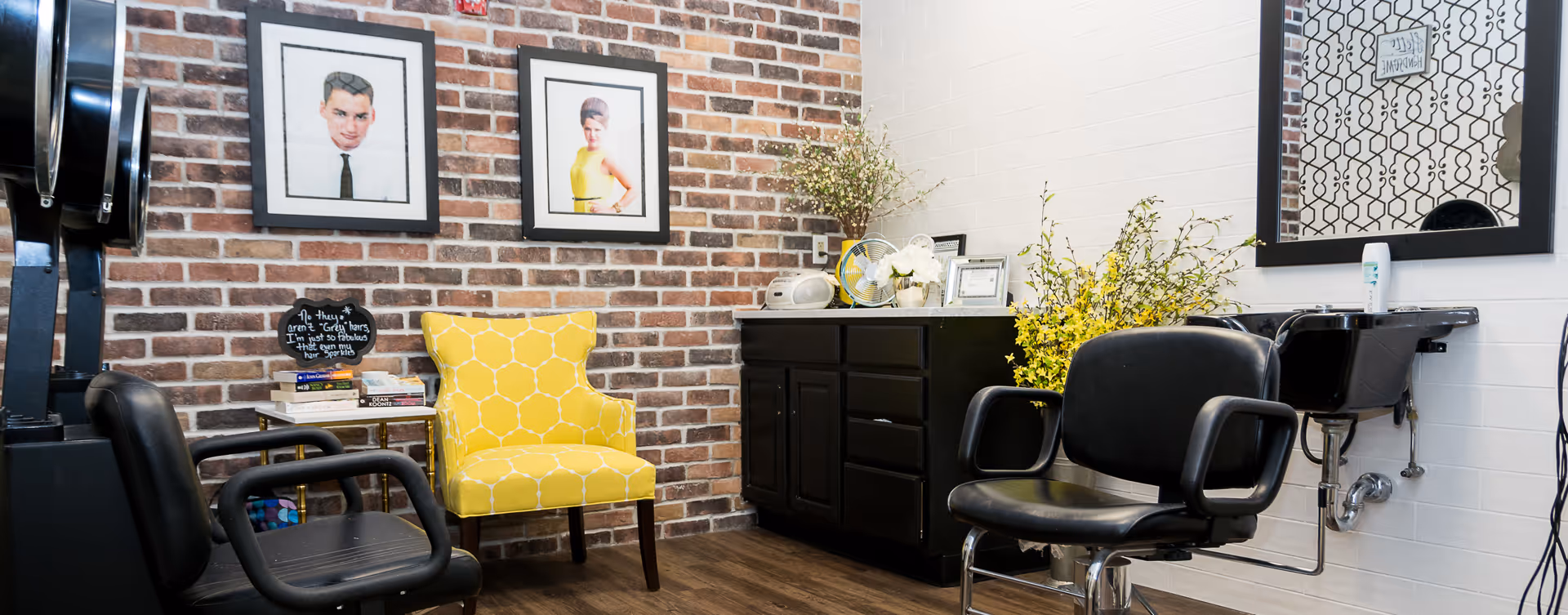 Interior of a hair salon in a senior living facility with chairs, mirrors, and brick wall.