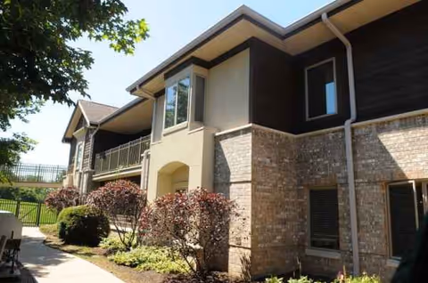 Exterior view of Concordia of Franklin Park: brick building with landscaping and walkway.
