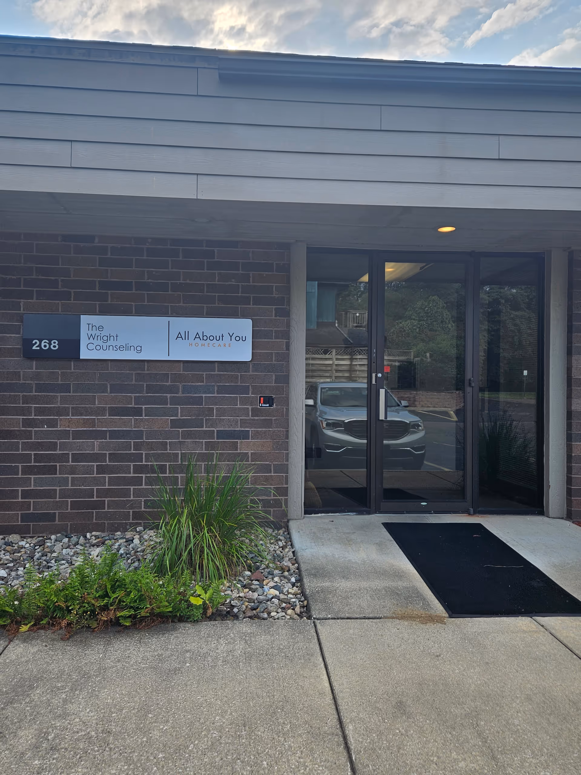 Exterior view of facility entrance with signage for The Wright Counseling and All About You Homecare.