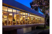 Lake Irma Retirement Home: glass-front exterior with a warmly lit dining area inside.