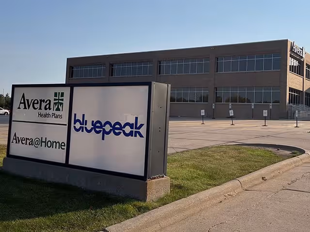 Exterior brick building with large windows and a sign reading Avera@Home and bluepeak.