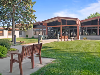 Exterior view of Good Samaritan Society Villa with glass entry and benches.