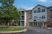 Exterior view of Anderson Farms Apartments senior living building with manicured landscaping.