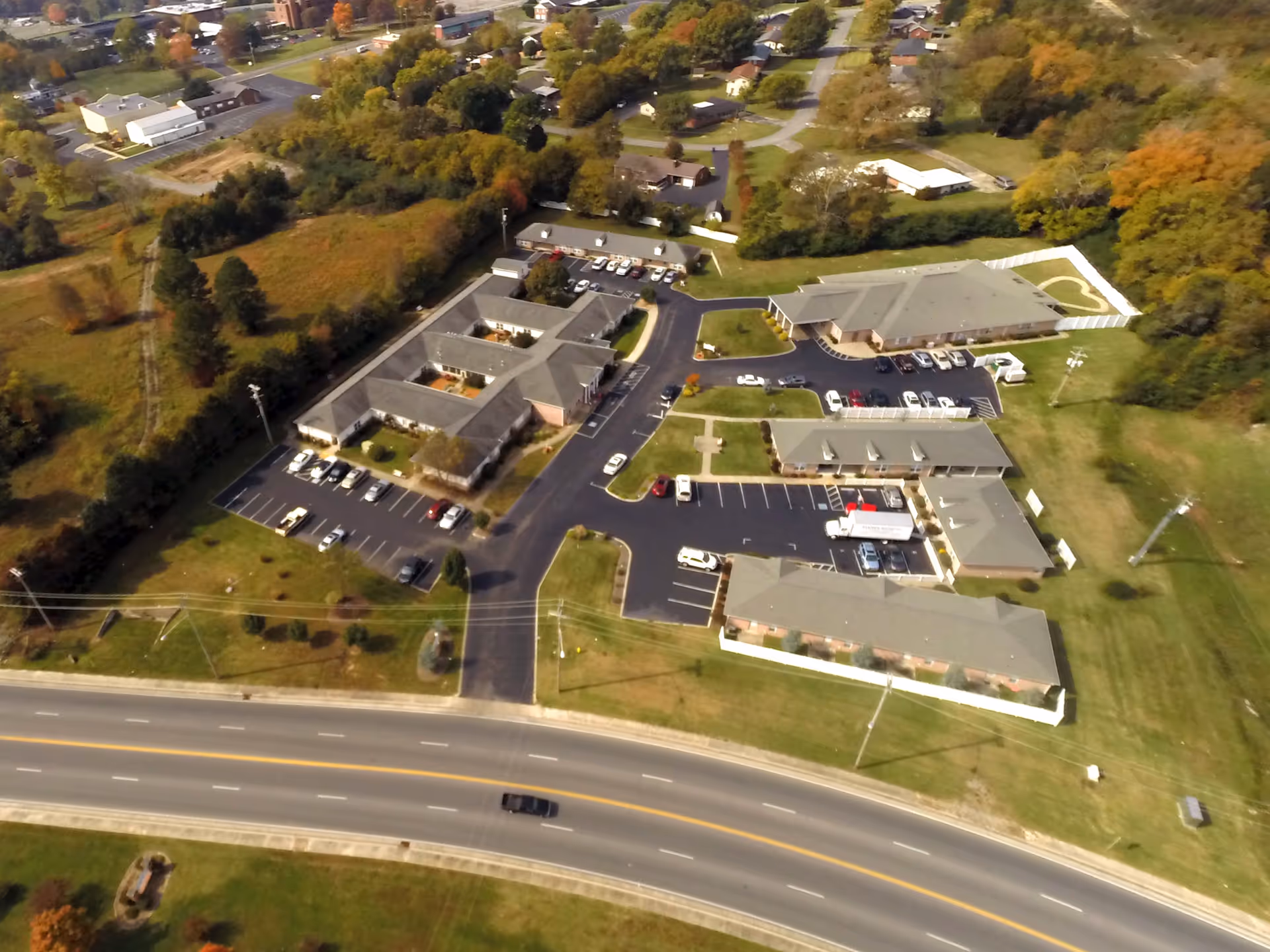 Aerial view of Carriage House Inn campus with connected buildings and parking.