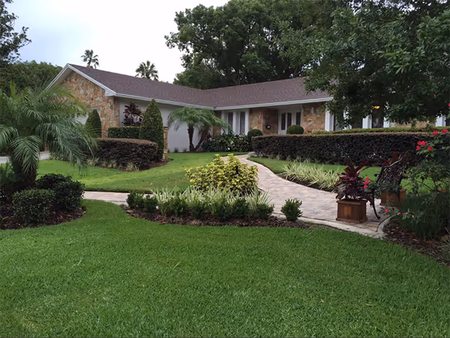 Front exterior view of Hilltop Manor with a landscaped lawn and walkway.