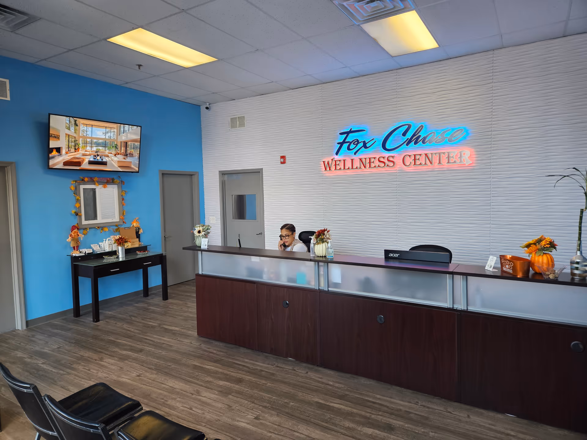 Reception area of Fox Chase Wellness Center with a long counter and receptionist.