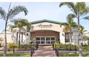 Front entrance of Avante at Melbourne senior living facility with palm trees.