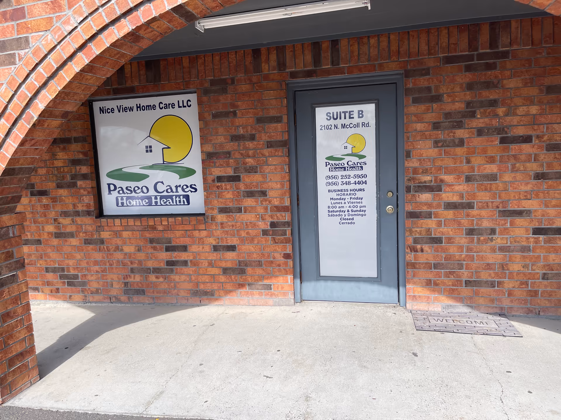 Brick building entrance with signs for Nice View Home Care and Suite B.