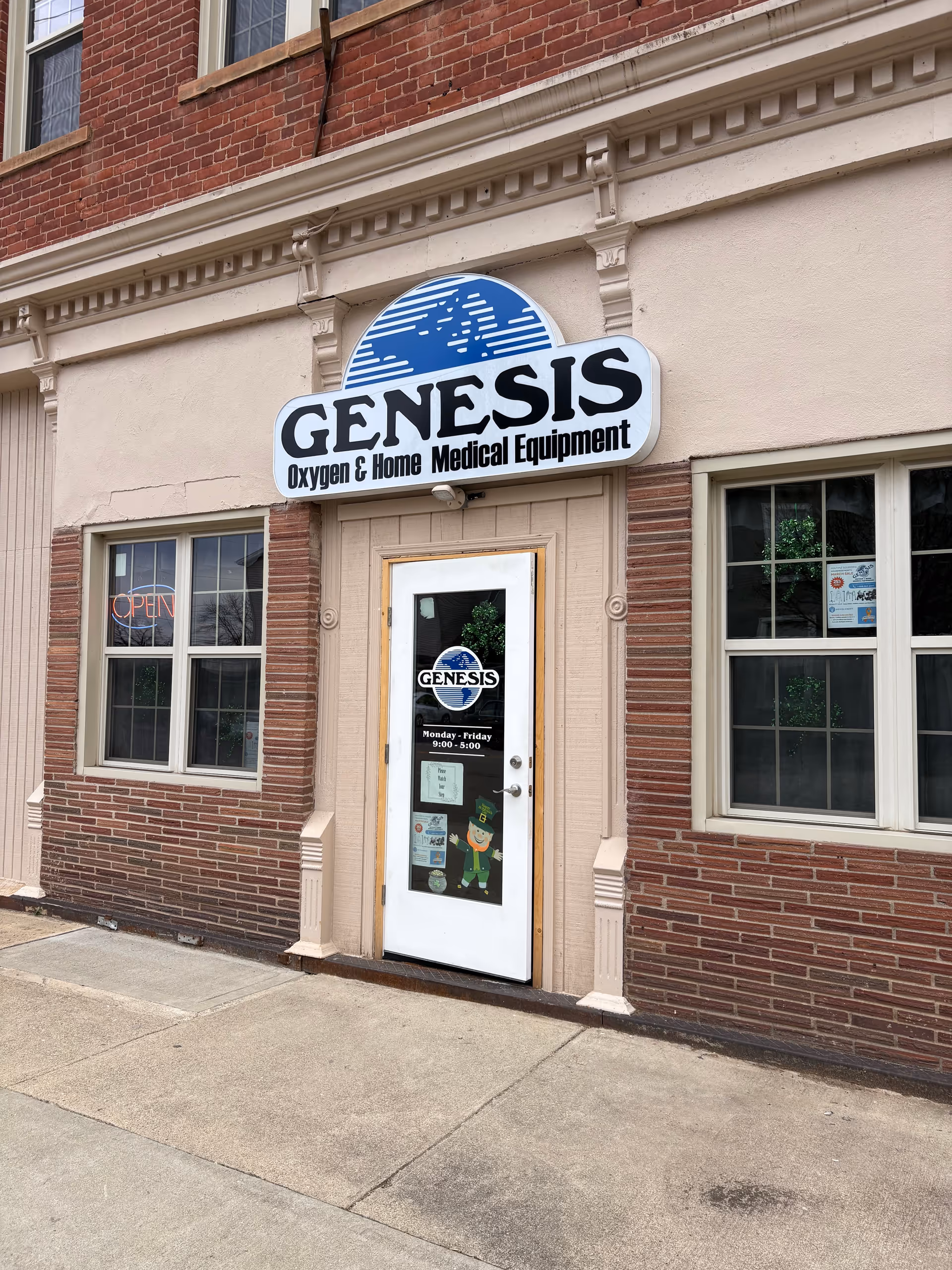 Exterior facade of Genesis Oxygen & Home Medical Equipment storefront with sign and door.
