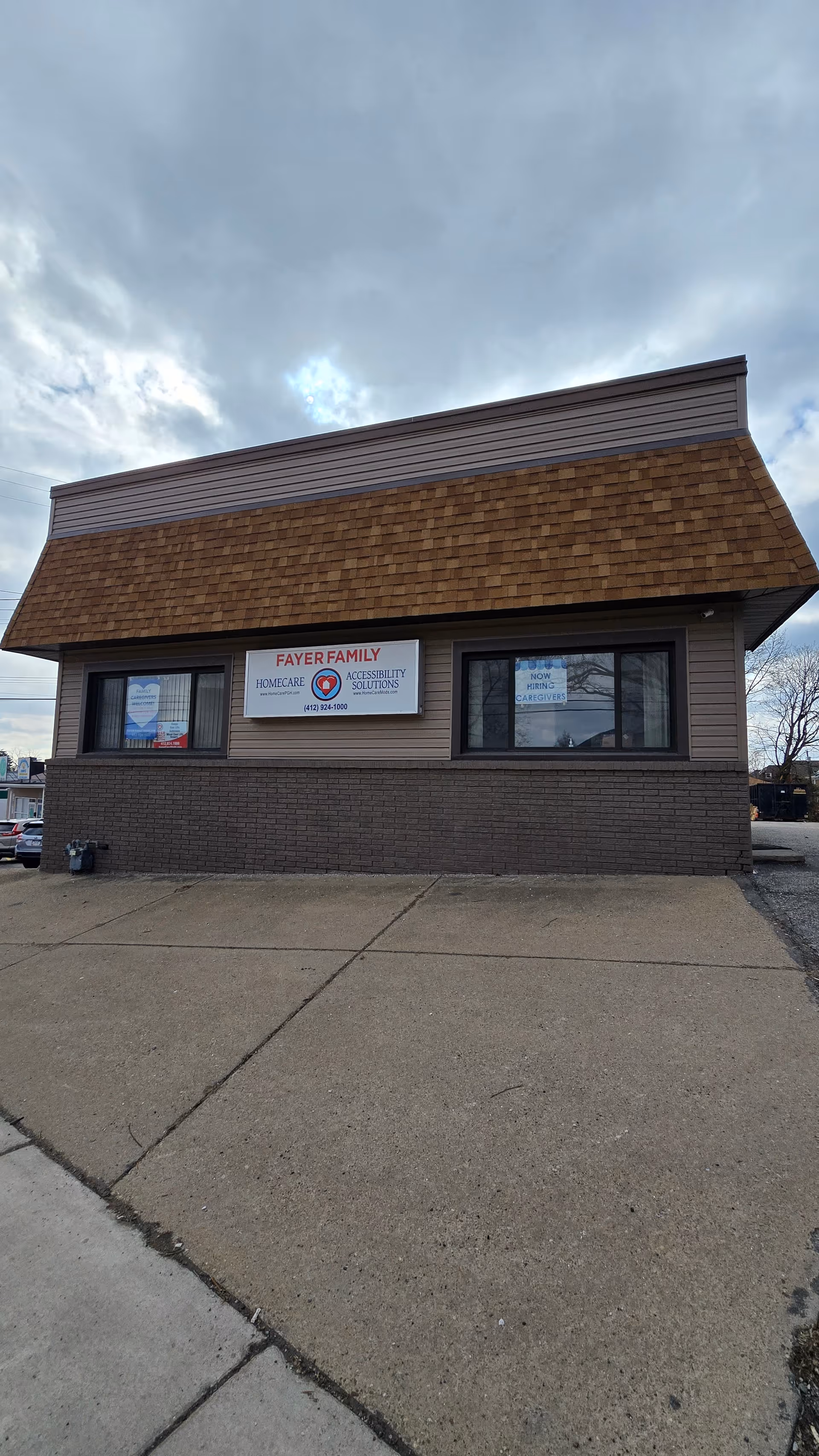 Exterior view of a brown, single-story building with a Fayer Family Homecare sign.