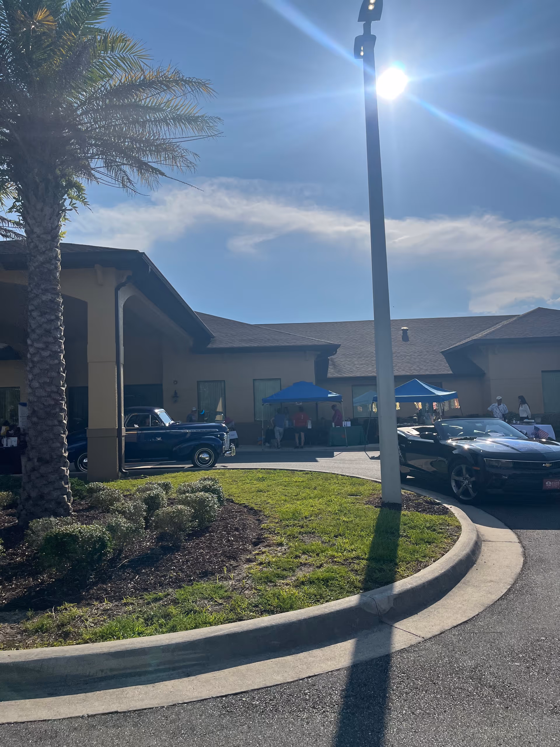 Exterior view of Home Halo of Northeast Florida with a curved driveway and tents outside.