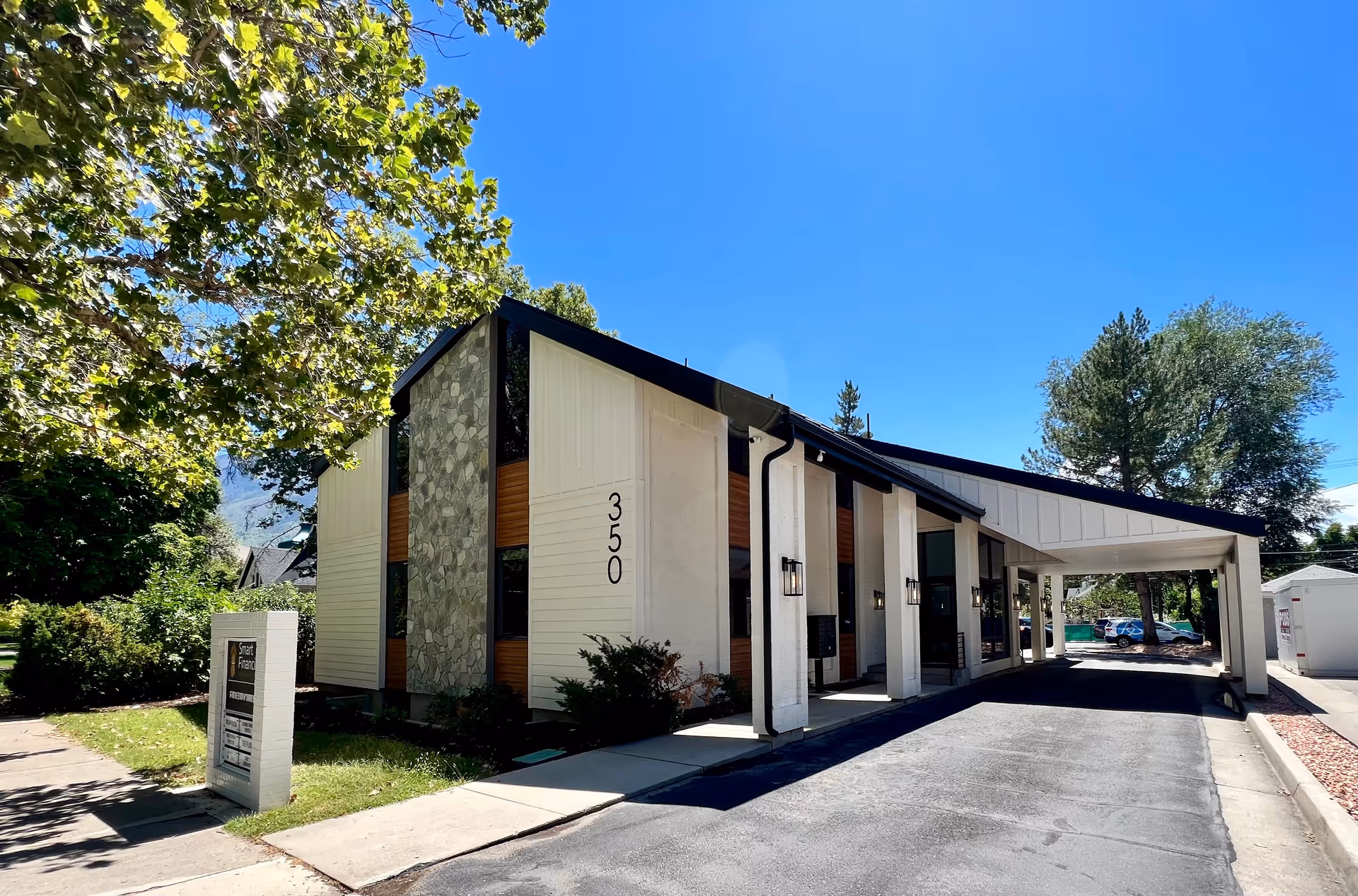 Modern, single-story senior care building with a covered front entrance and driveway.