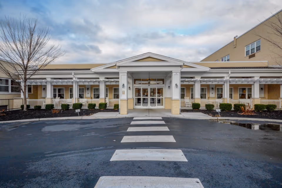 Front exterior view of St Monica Center entrance with crosswalk and landscaping.