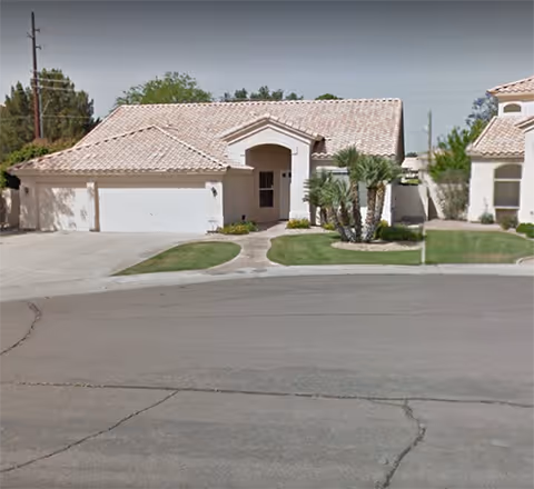 Front view of a single-story Summerhaven Assisted Living building with a curved driveway.