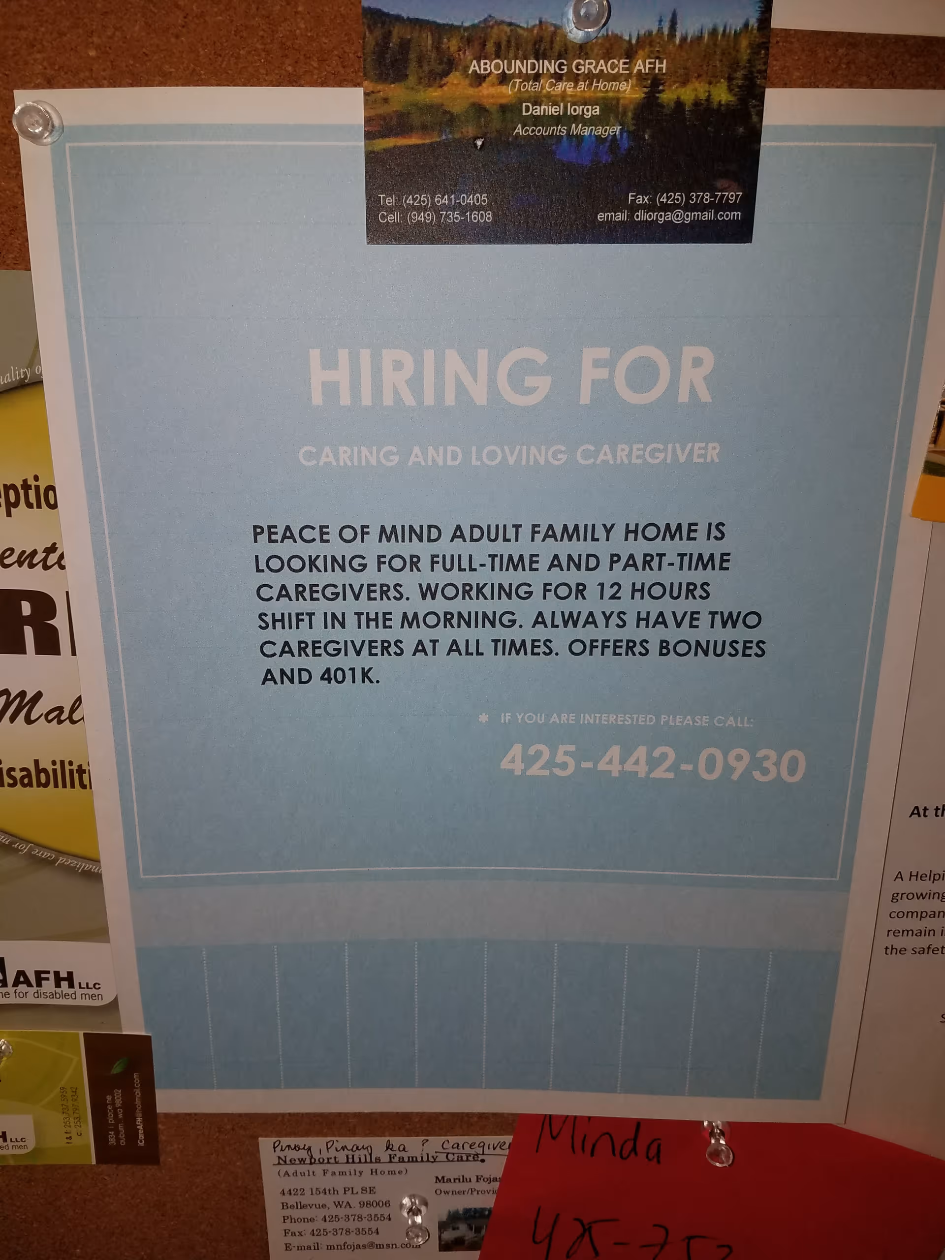 Blue 'HIRING FOR' caregiver recruitment poster pinned to a corkboard.