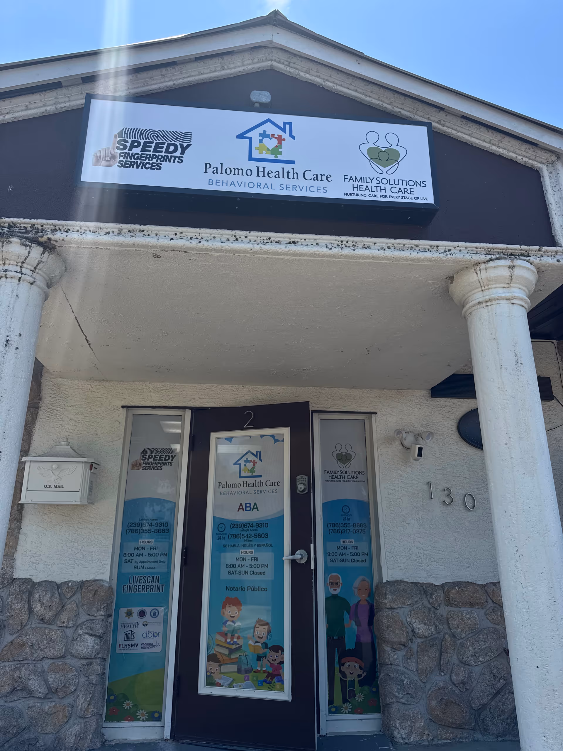 Front exterior of Palomo Health Care building with large sign and entrance door.