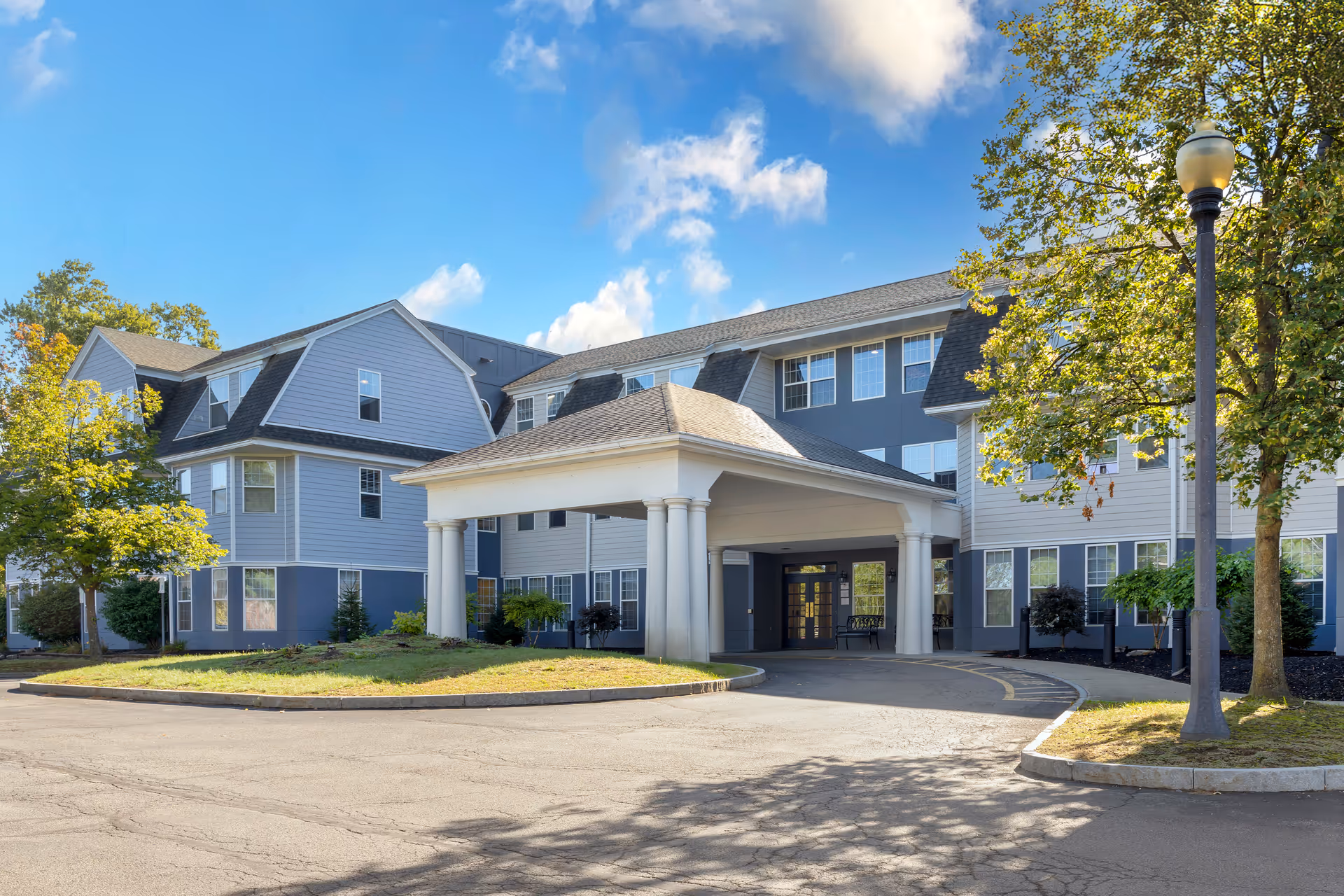 A multi-story Brookdale Niskayuna senior living building with a covered entrance and driveway.