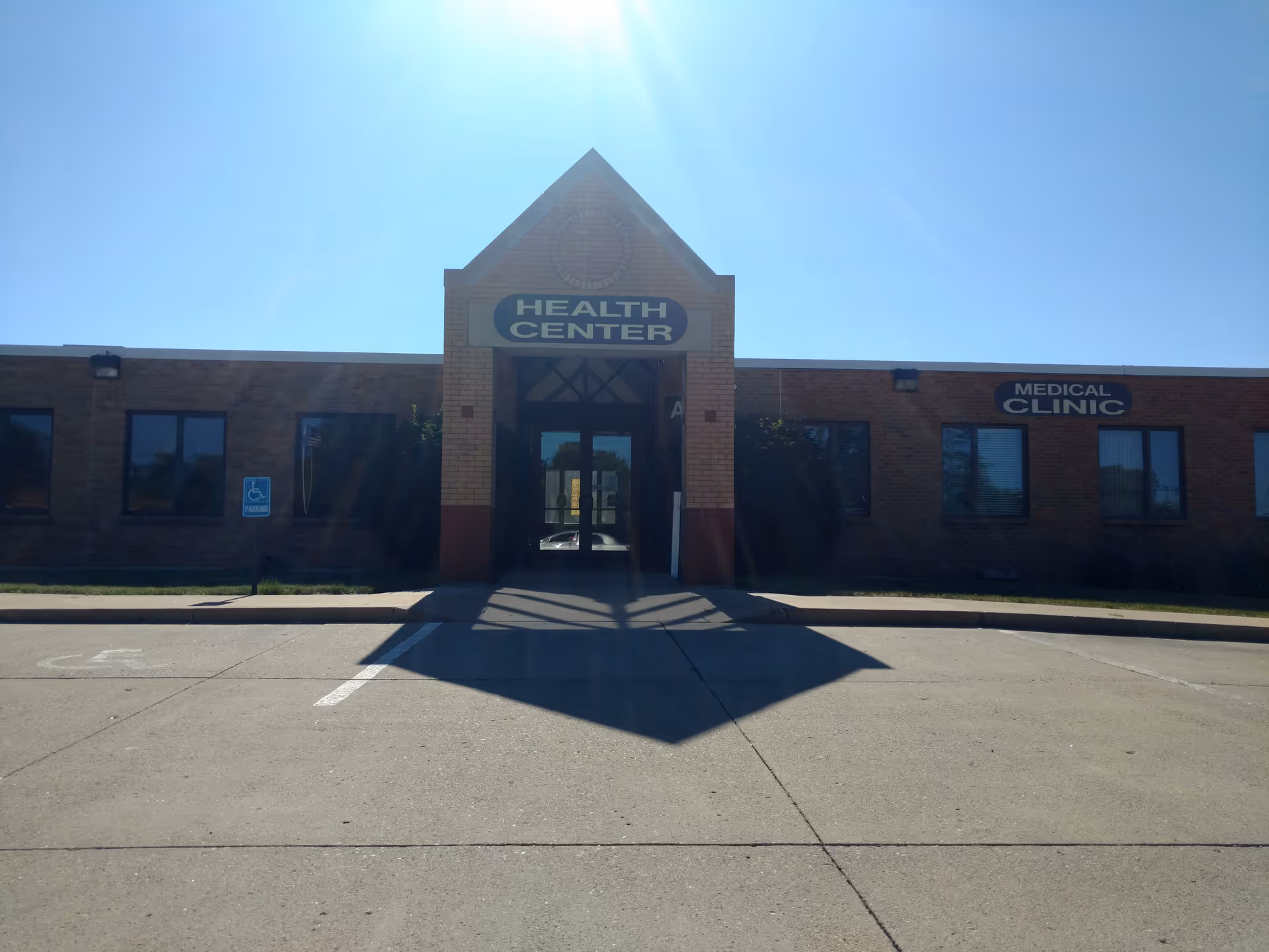 Brick health center building with central entrance and Health Center sign.