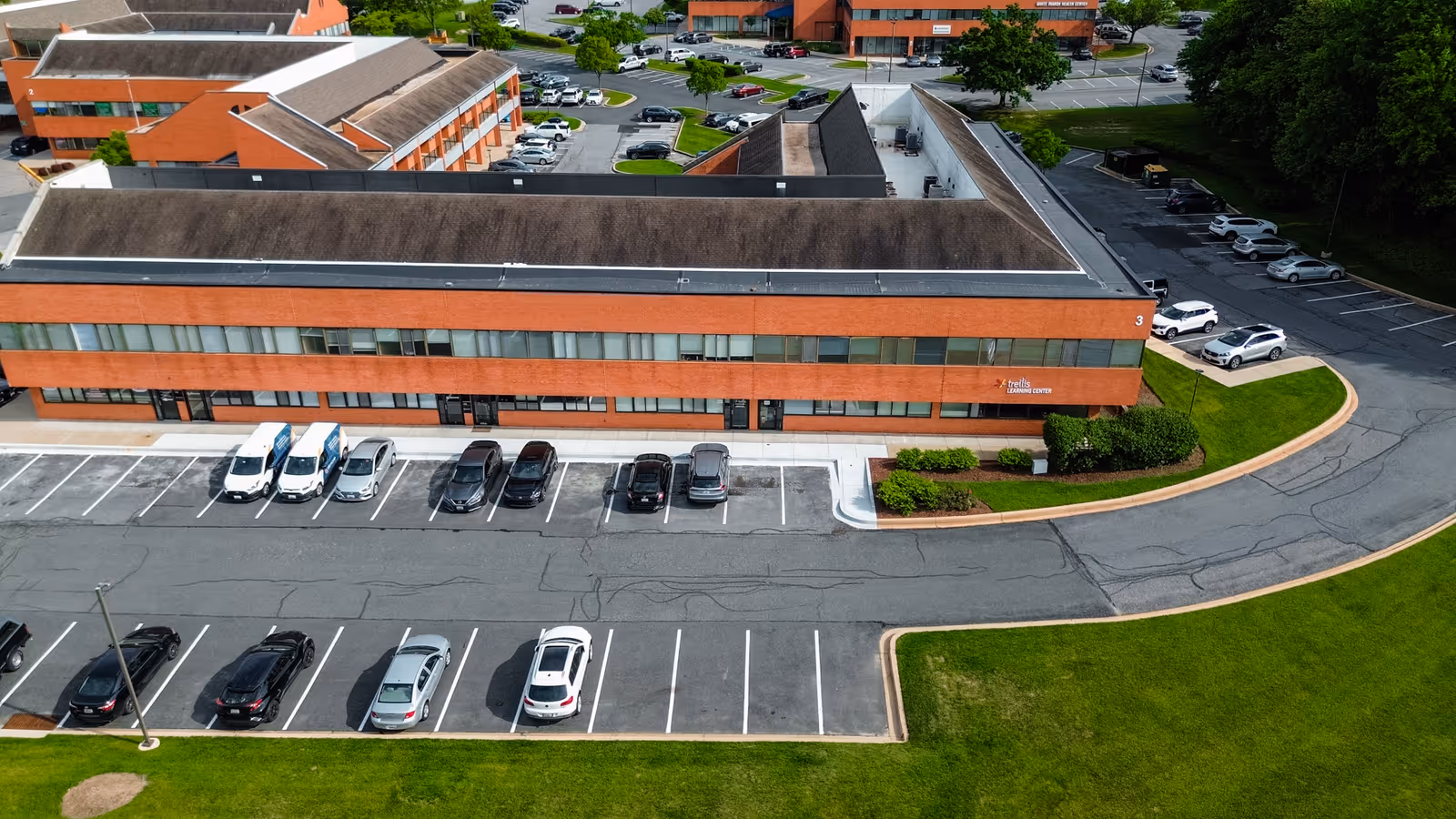 Aerial view of Trellis Services senior living campus with parking lots and landscaped grounds.