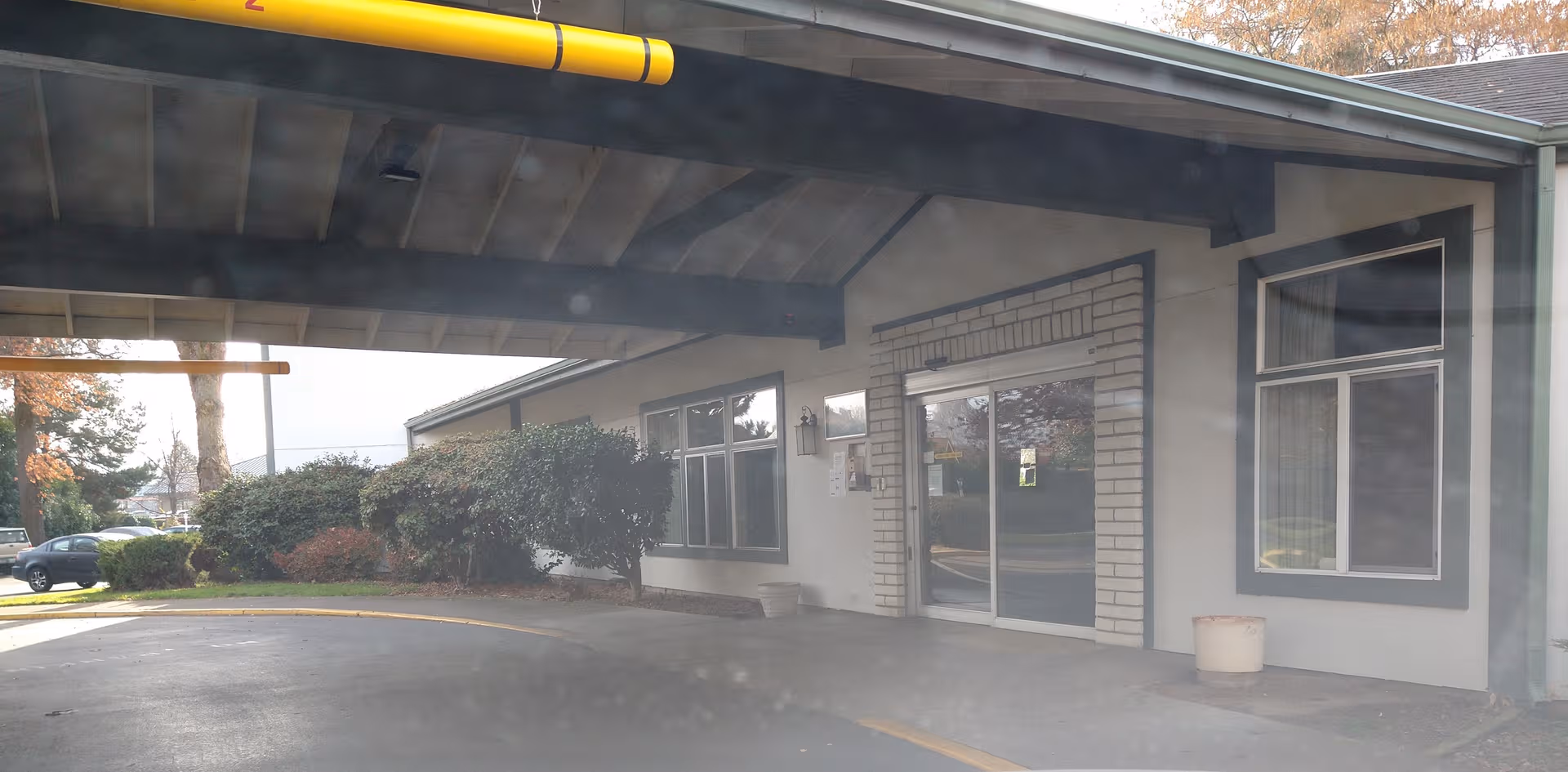 Exterior view of Rogue River Estates Retirement front entrance under a covered drive.