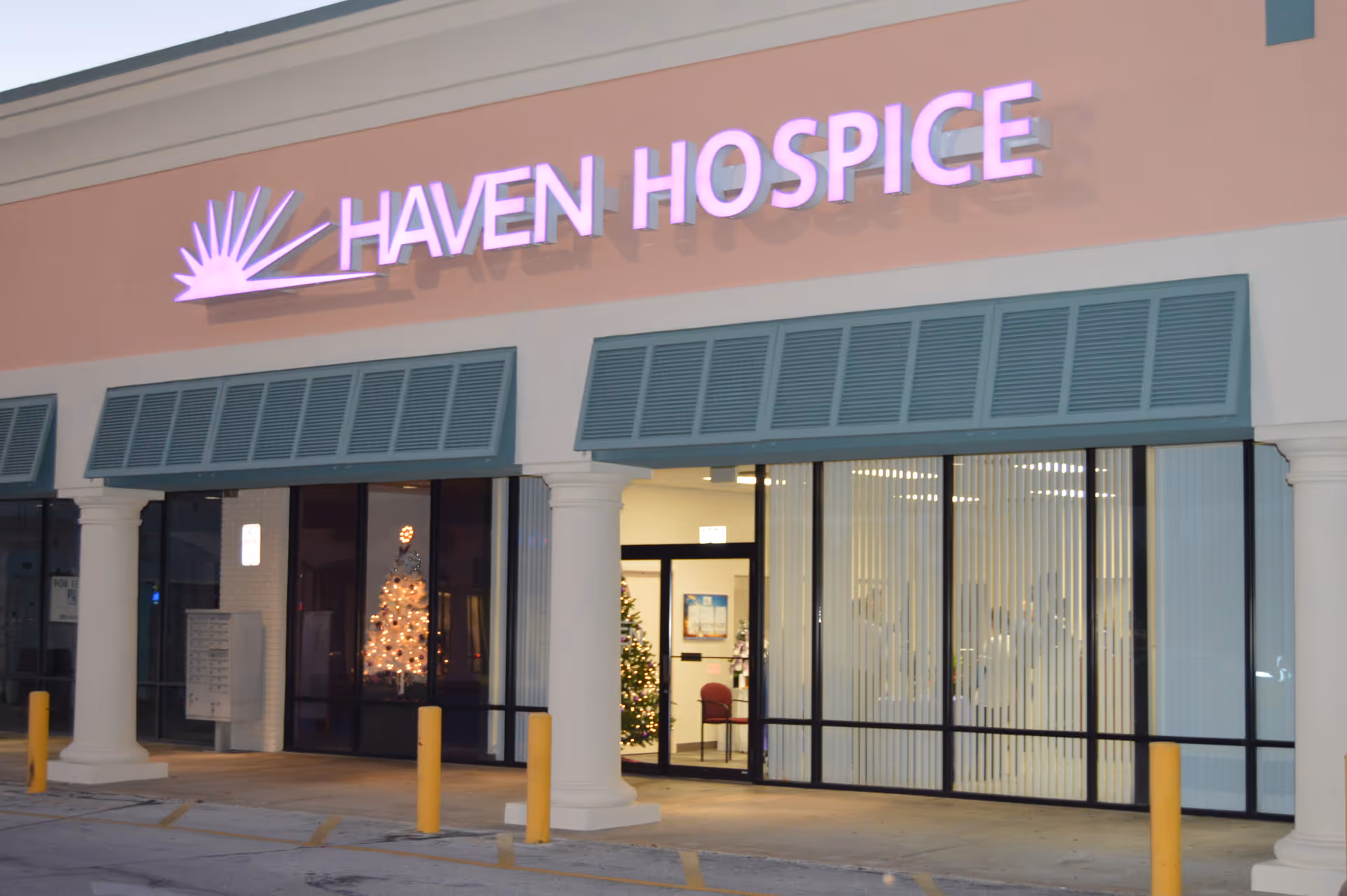 Exterior of Haven Hospice storefront with glass doors and purple sign