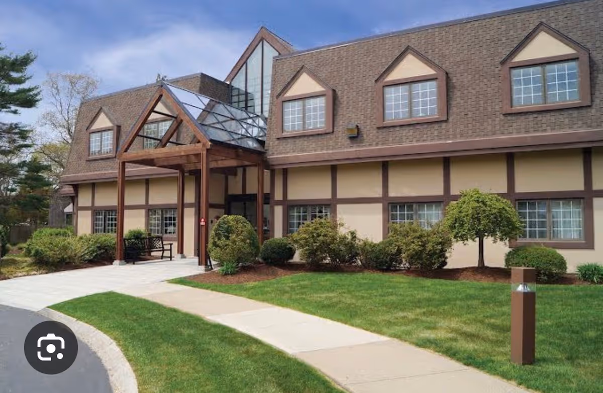 Exterior view of Sippican Health Care Center with an entry canopy and landscaped grounds.