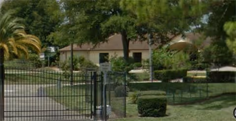 Entrance gate and landscaped grounds with a building in the background at Lakewood Retirement Center.