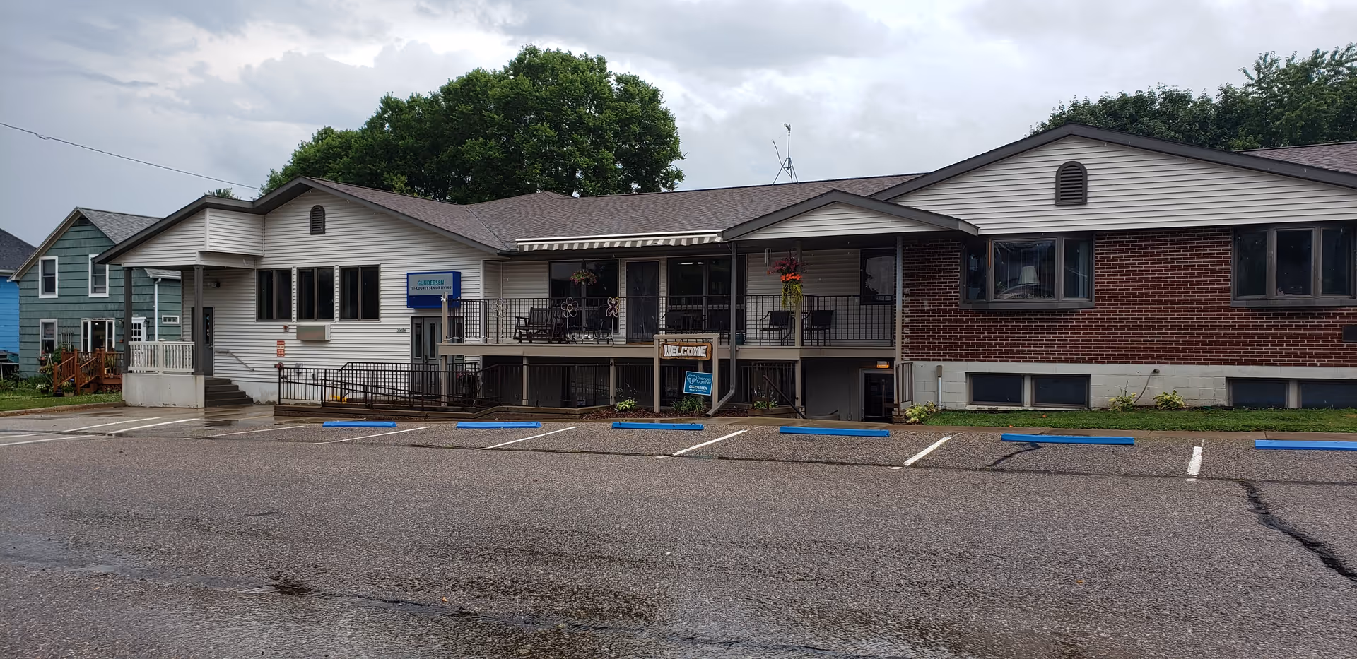 Single-story senior care building with a front porch, parking spaces, and brick/siding exterior.