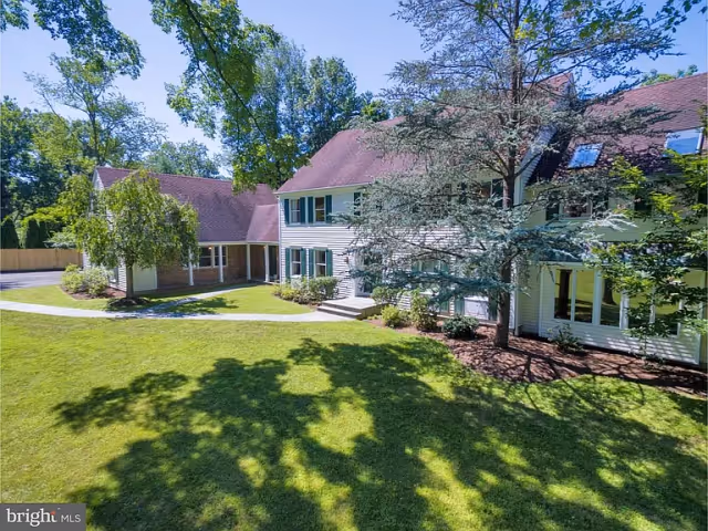 A well-maintained senior living facility with green lawns and trees.