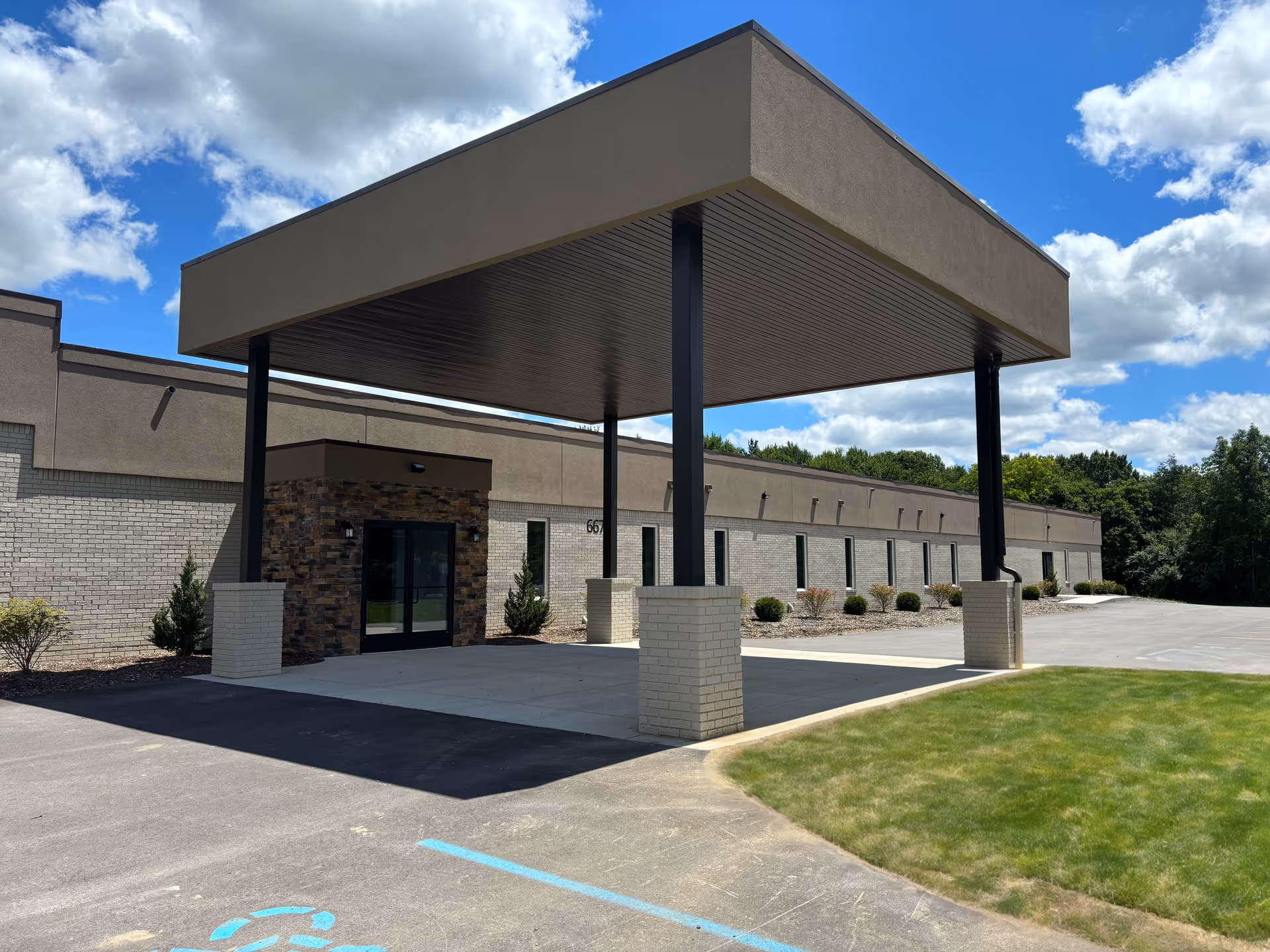 Front exterior of North Branch Assisted Living with a large entrance canopy.