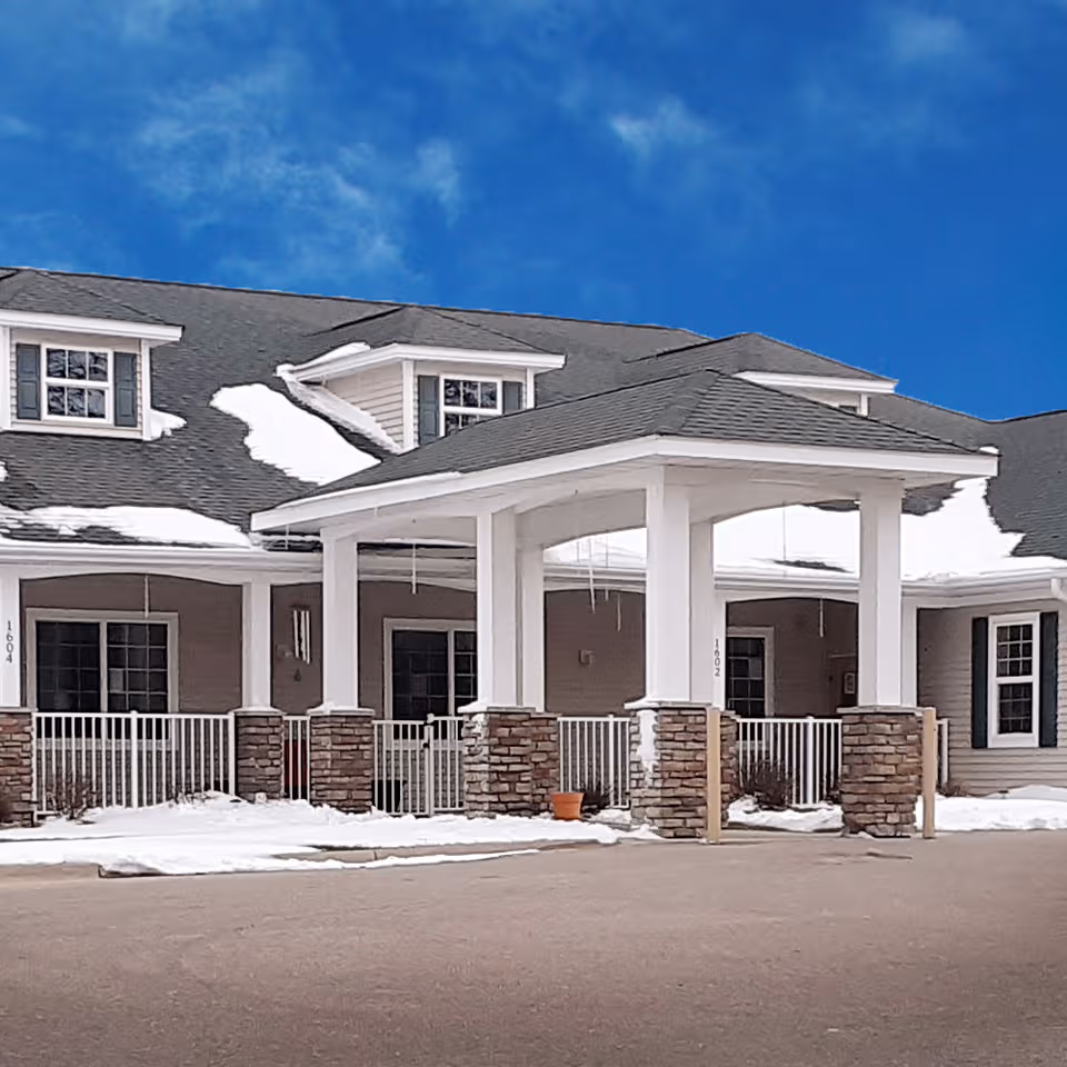 Front view of Prairie Senior Cottages of Albert Lea exterior with snow and blue sky.
