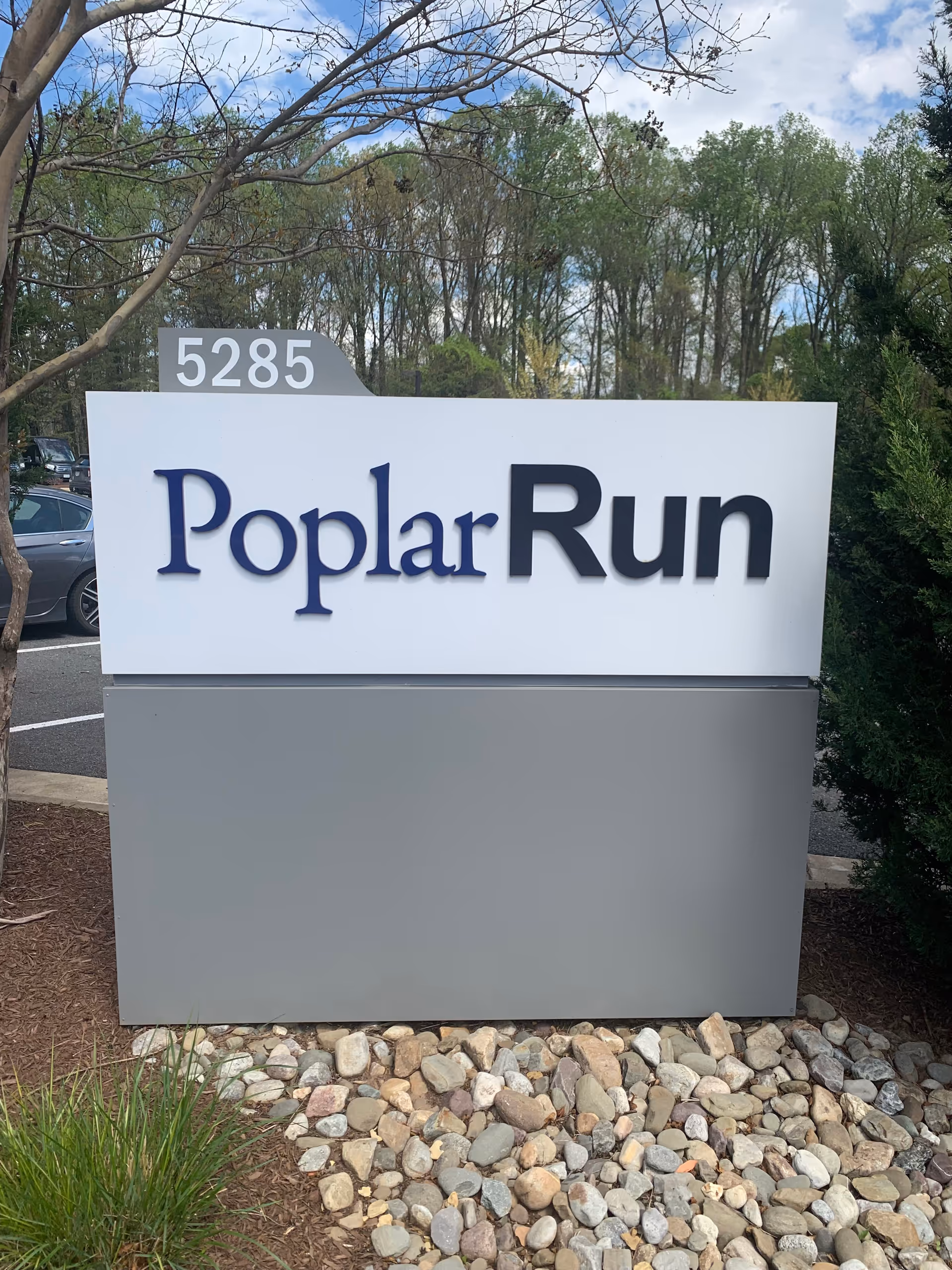 A large exterior sign reads PoplarRun at 5285, set among trees.