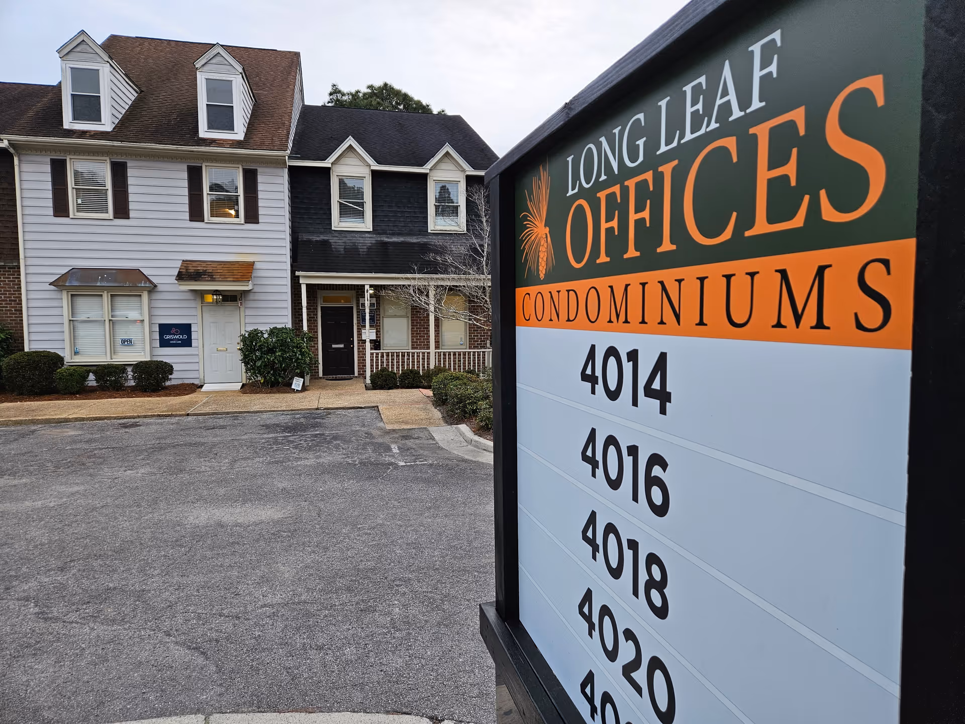 Exterior of a building with a large sign reading Longleaf Offices Condominiums.