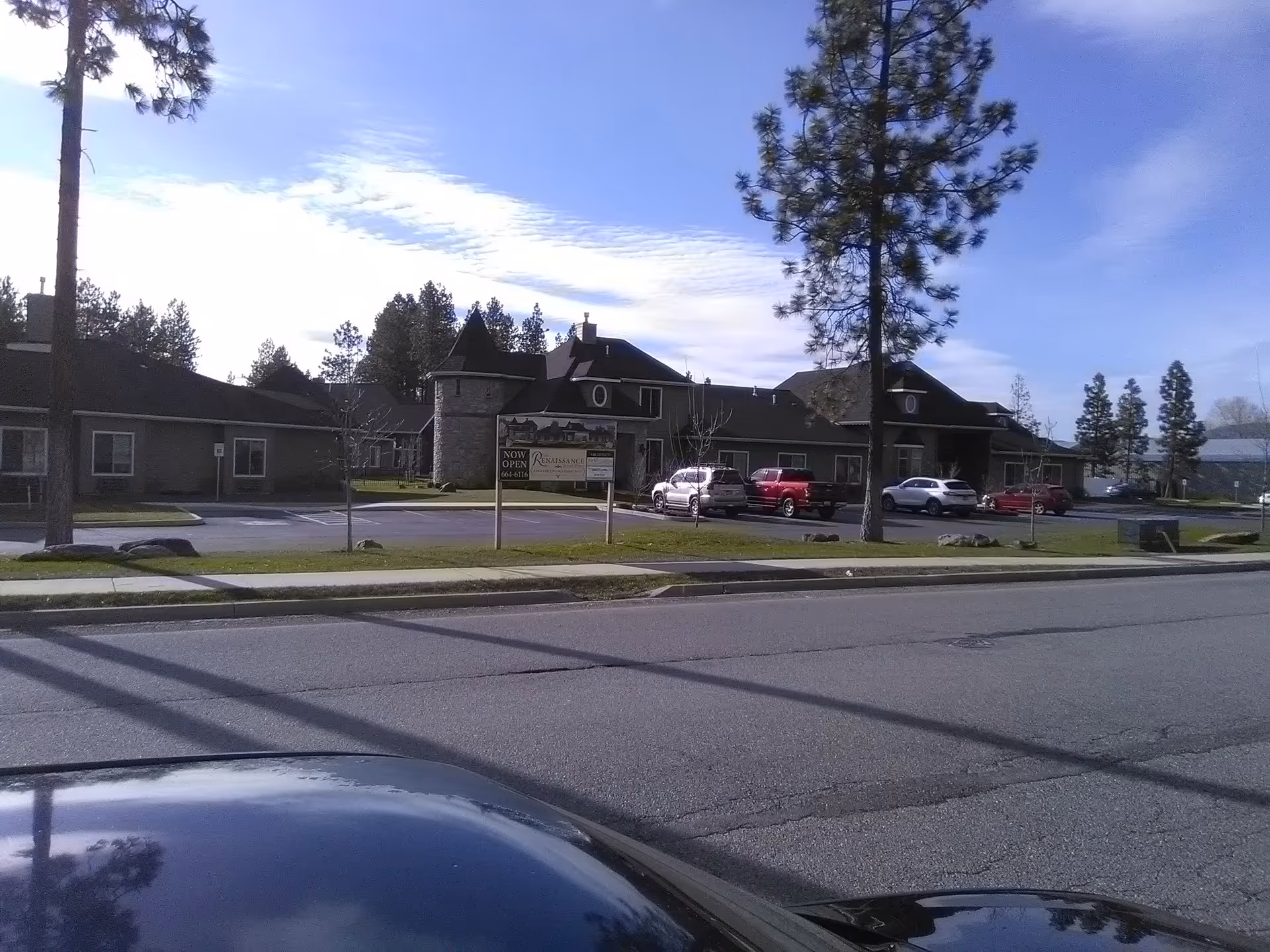 Exterior view of The Renaissance at Coeur D'Alene, a senior living facility with a parking lot.