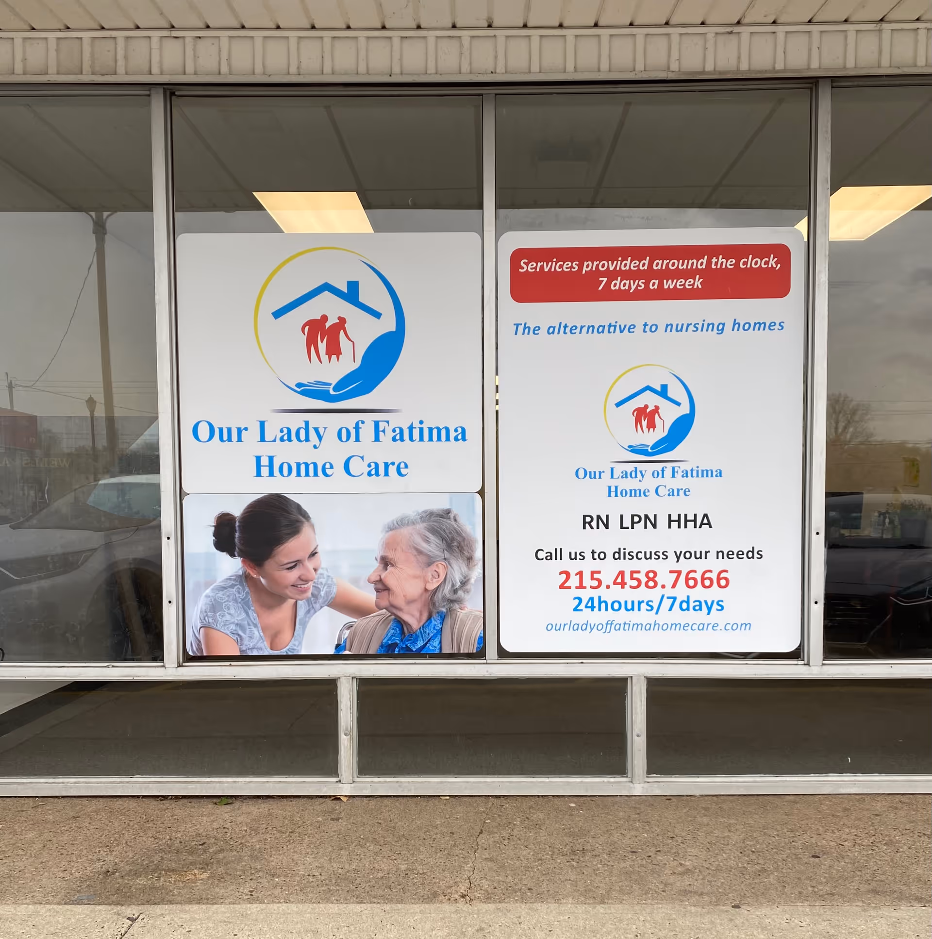 Storefront window displays Our Lady of Fatima Home Care signs and a caregiver with elderly client