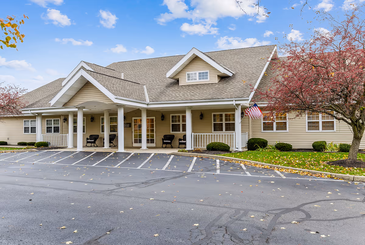 Addison Place senior living facility with a covered front porch and a parking lot.