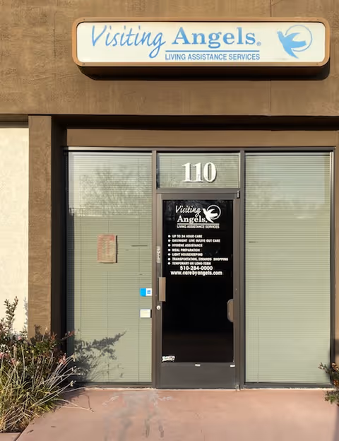 Exterior view of Visiting Angels entrance with sign and glass doors.