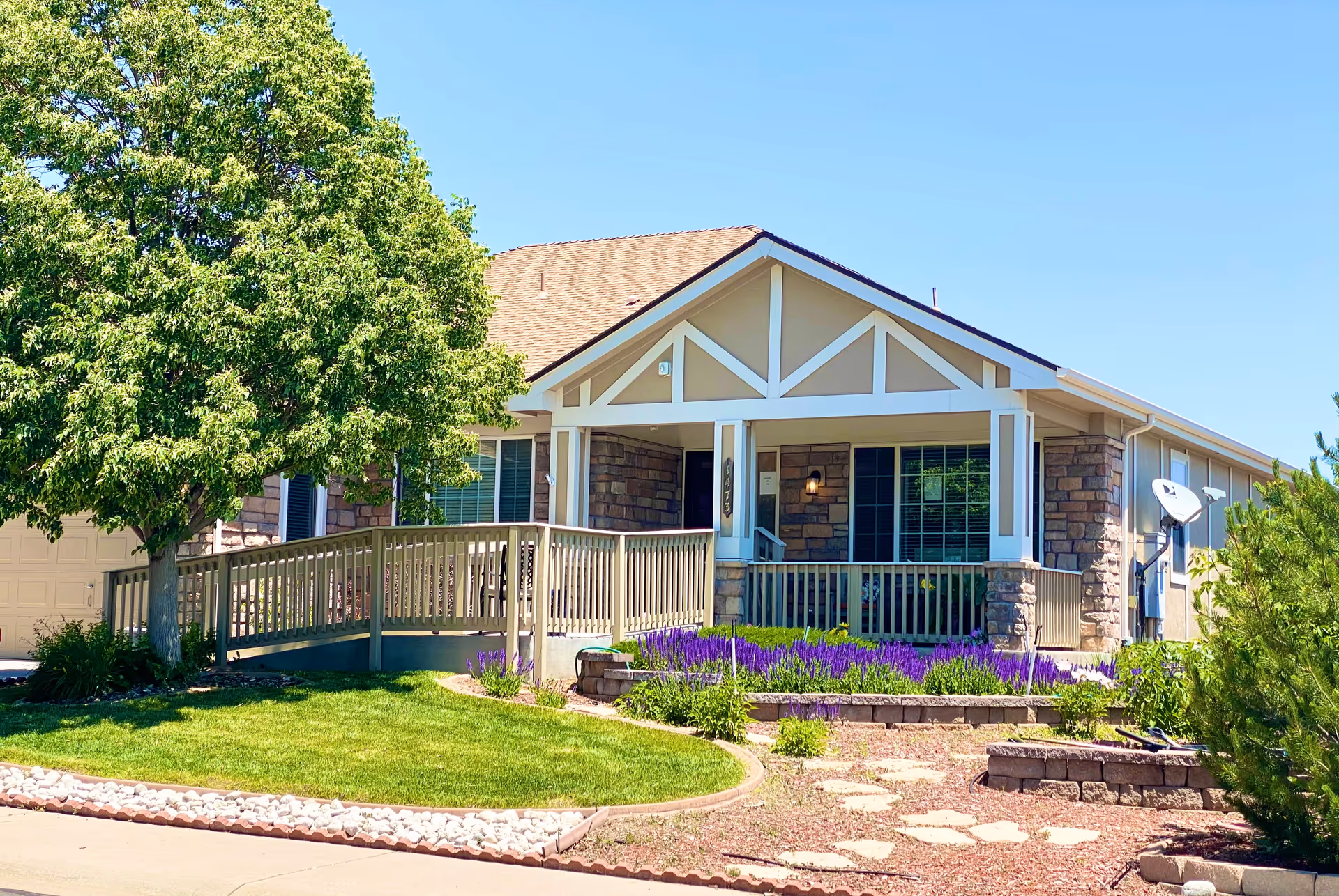 Front view of Gardens Care Senior Living - Homestead, a home with porch and landscaped yard.