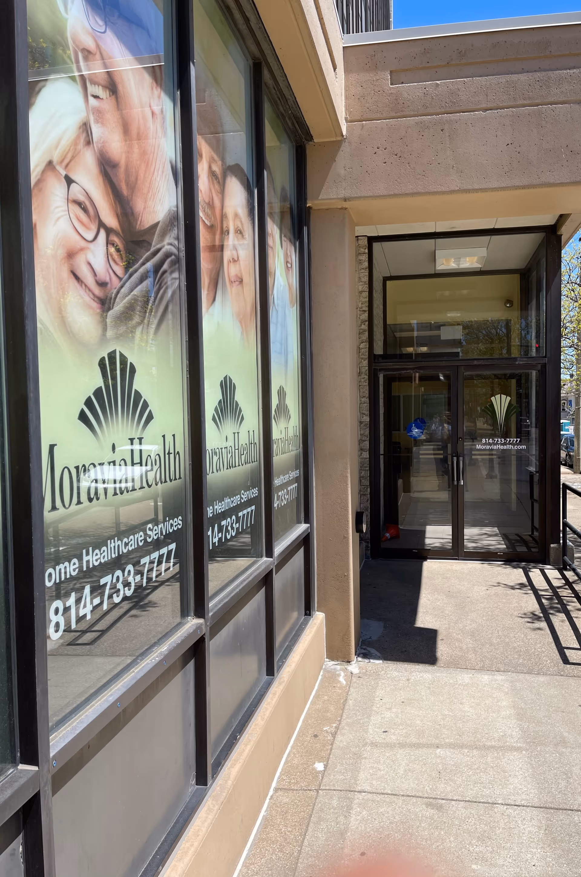 Exterior view of Moravia Health Erie building entrance with large window graphics.