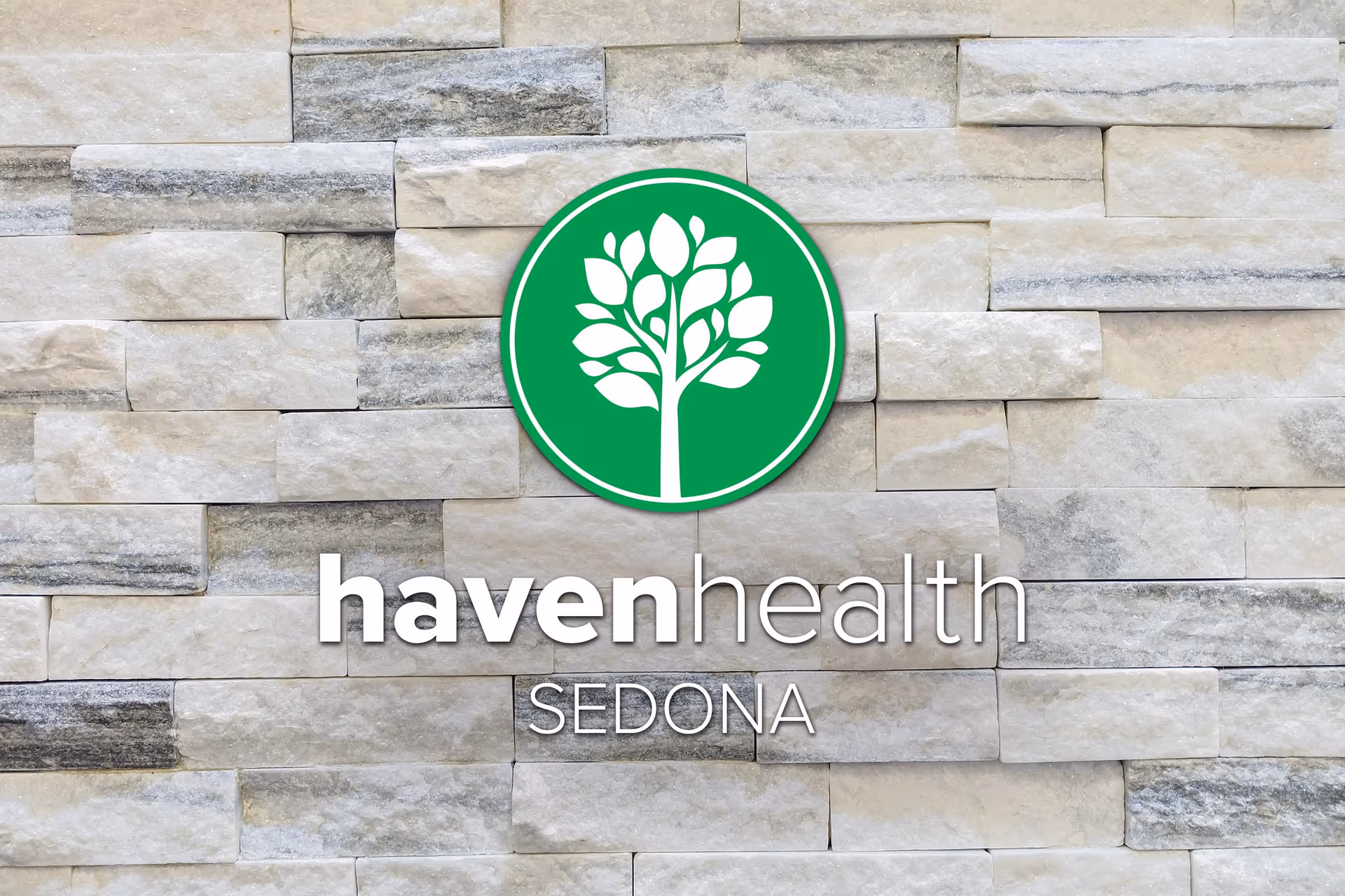 Signage for Haven Health Sedona on a stone exterior wall.