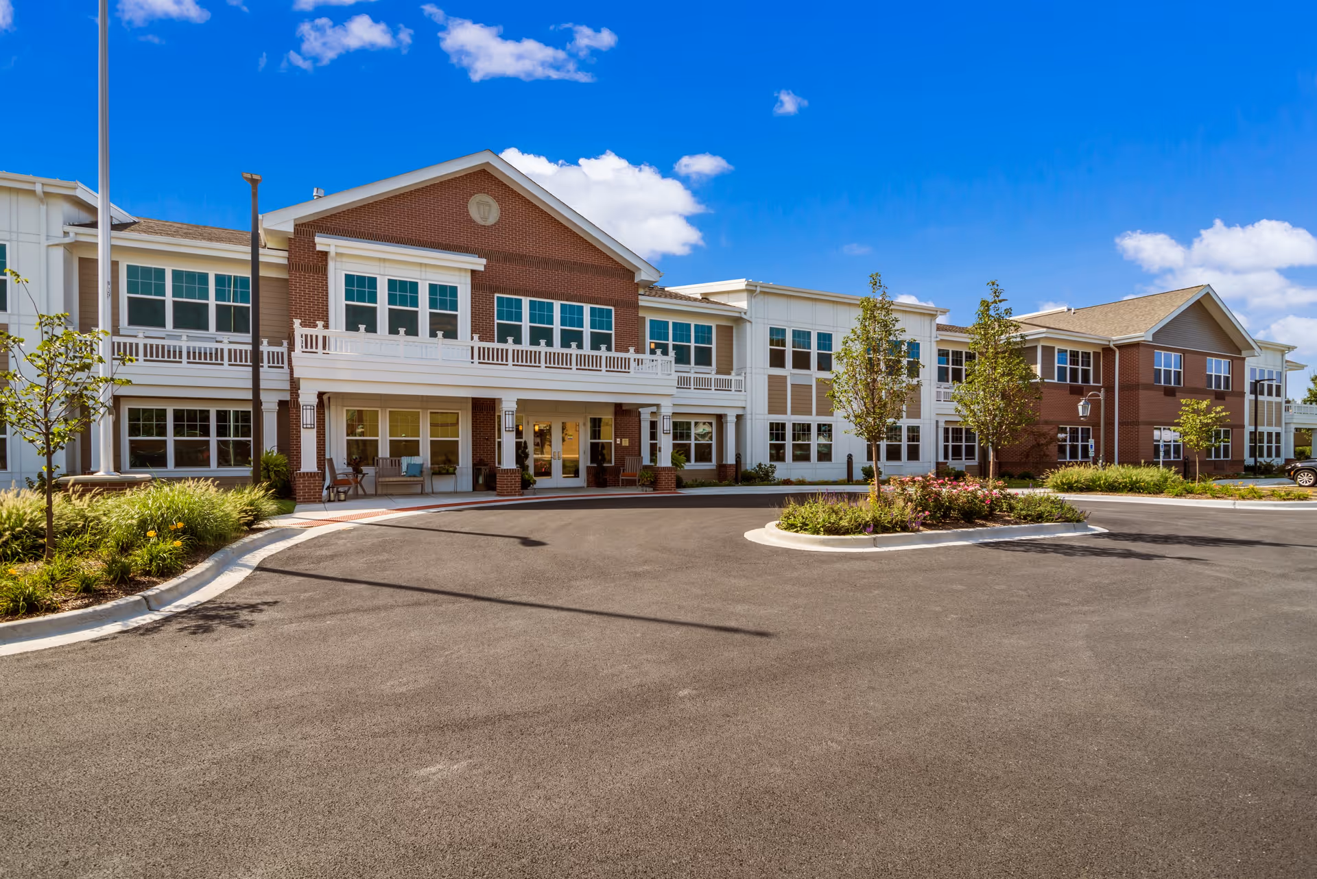 Exterior view of Grace Point Place with brick facade, entrance, and circular driveway.