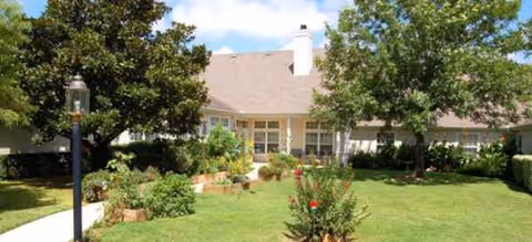 Front view of a Brookdale New Braunfels senior living building with lawn and landscaping