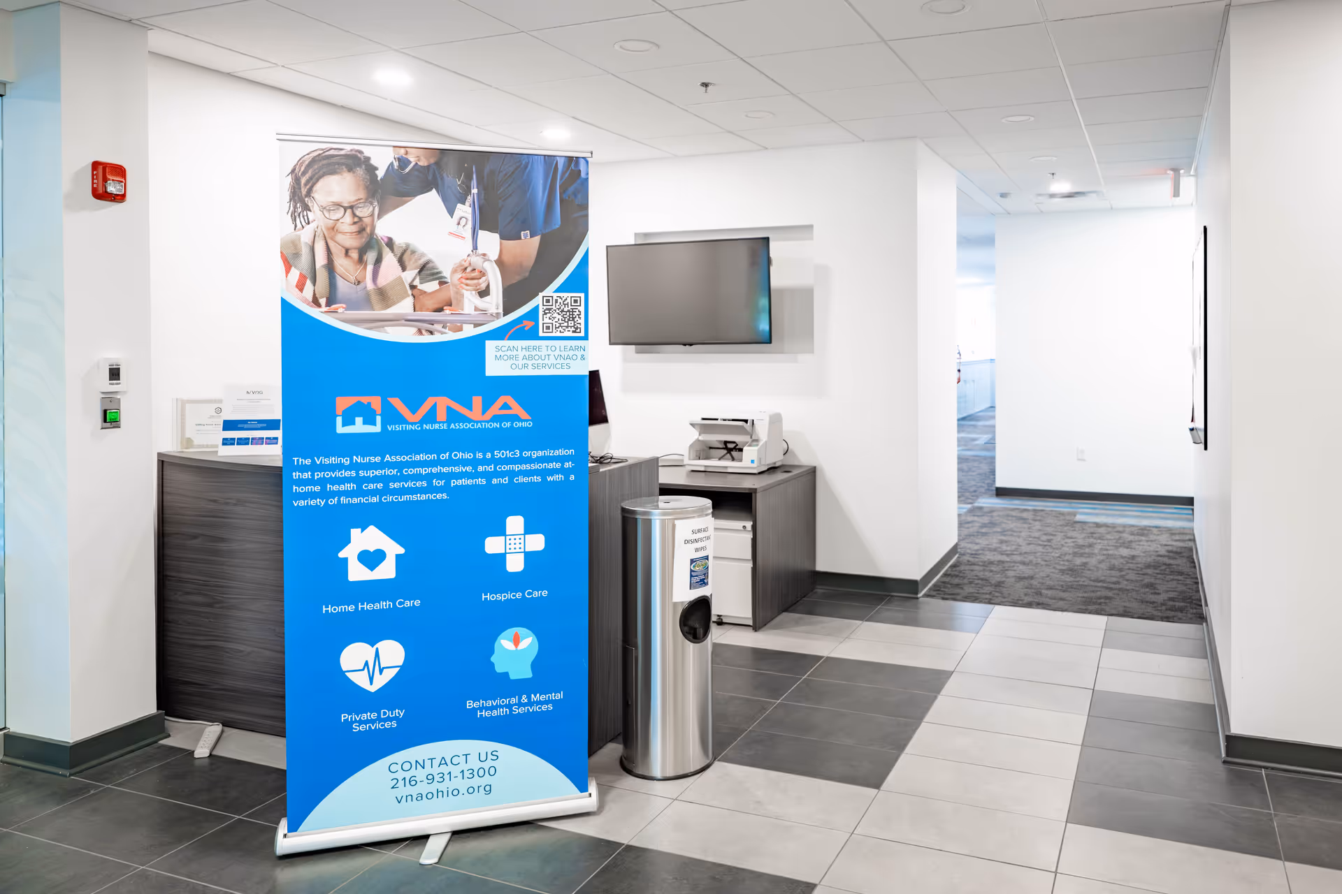 Reception area with a blue VNA of Ohio banner, desk, and hallway.