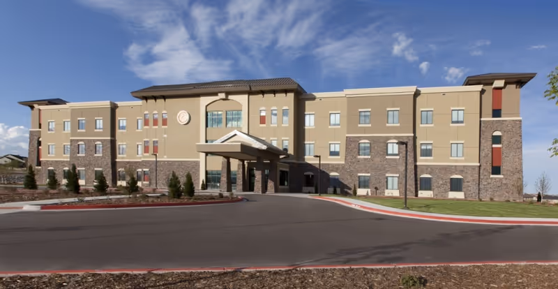 Exterior view of Center at Cordera senior living facility with entrance canopy.