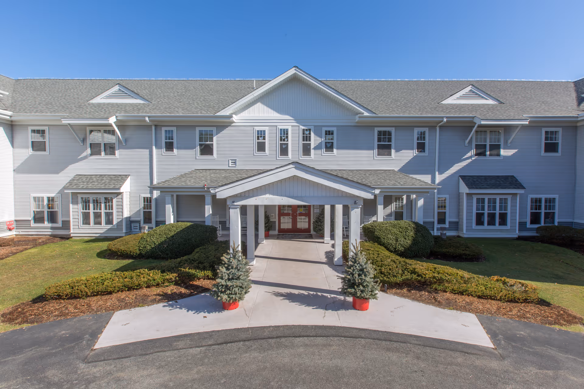 Front view of Brookdale Cape Cod facility entrance with walkway and shrubs.