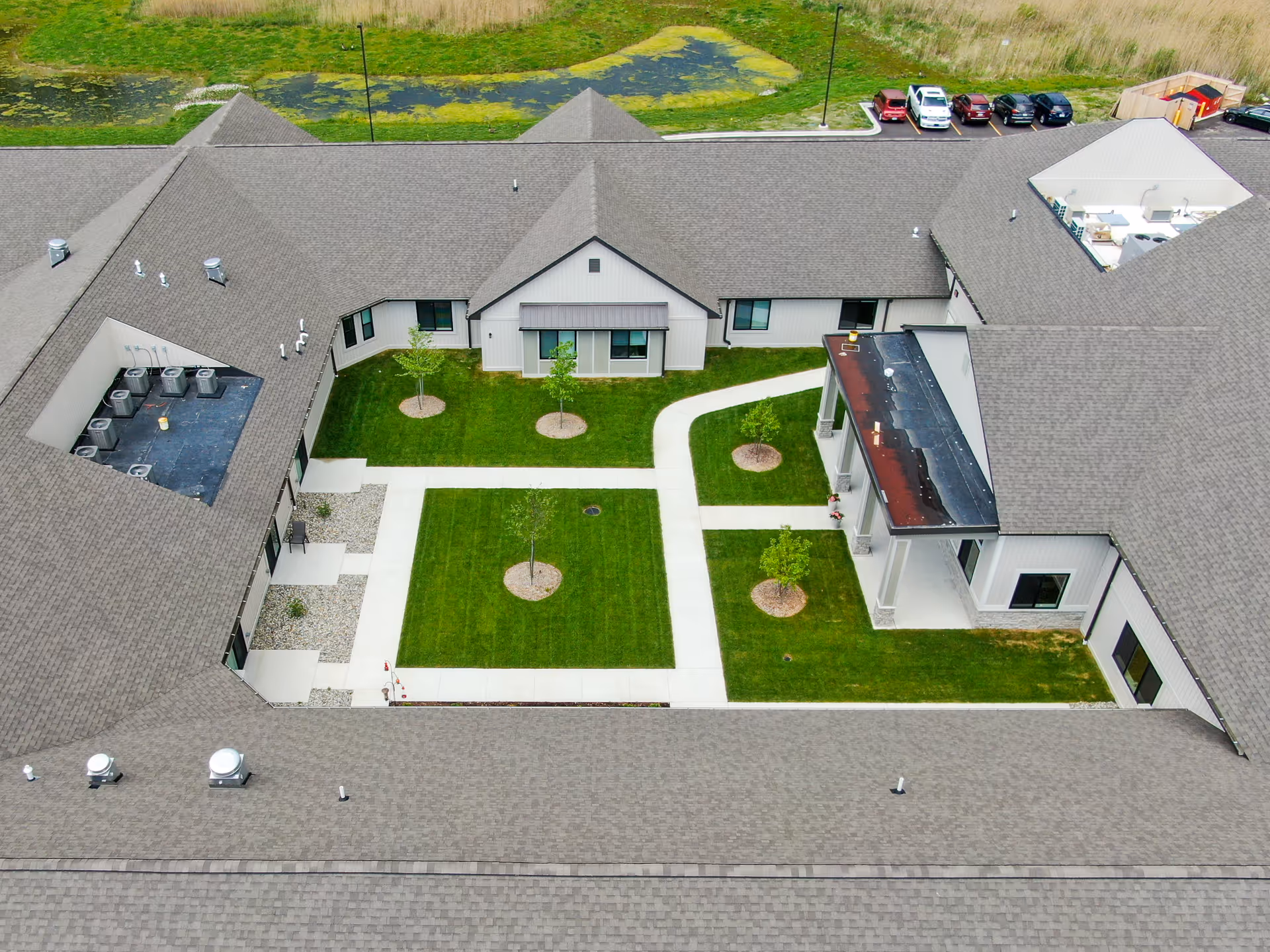 Aerial view of Grace Senior Living Kimball Twp, showing courtyard, lawns, and surrounding rooftops