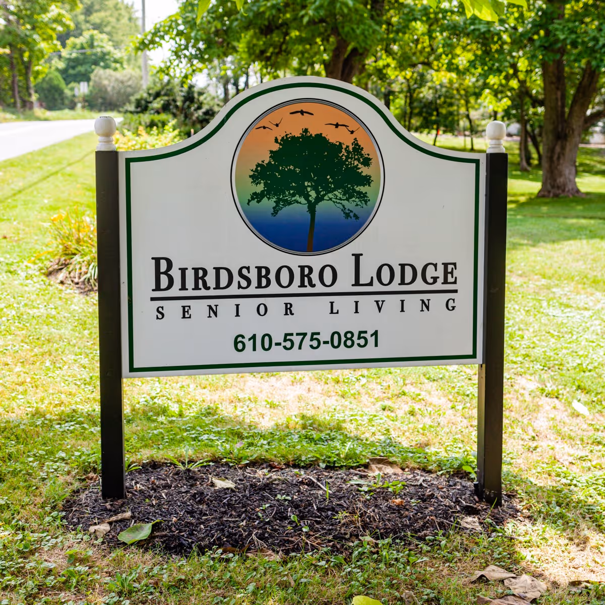 A large Birdsboro Lodge Senior Living sign standing on a grassy lawn.