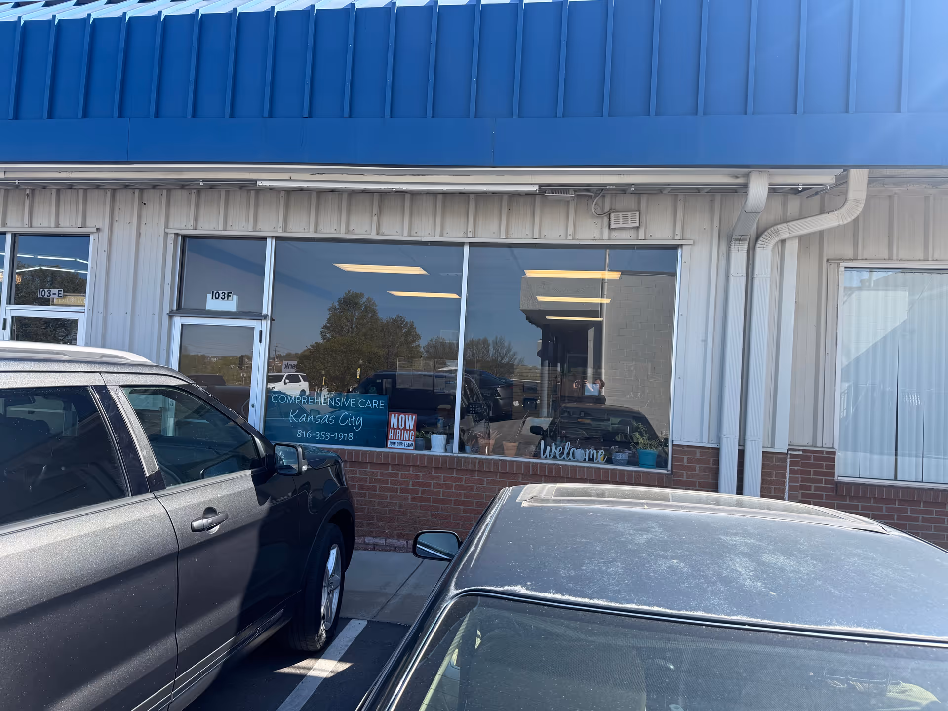 Front exterior of Comprehensive Care Kansas City building with large windows and parked cars.
