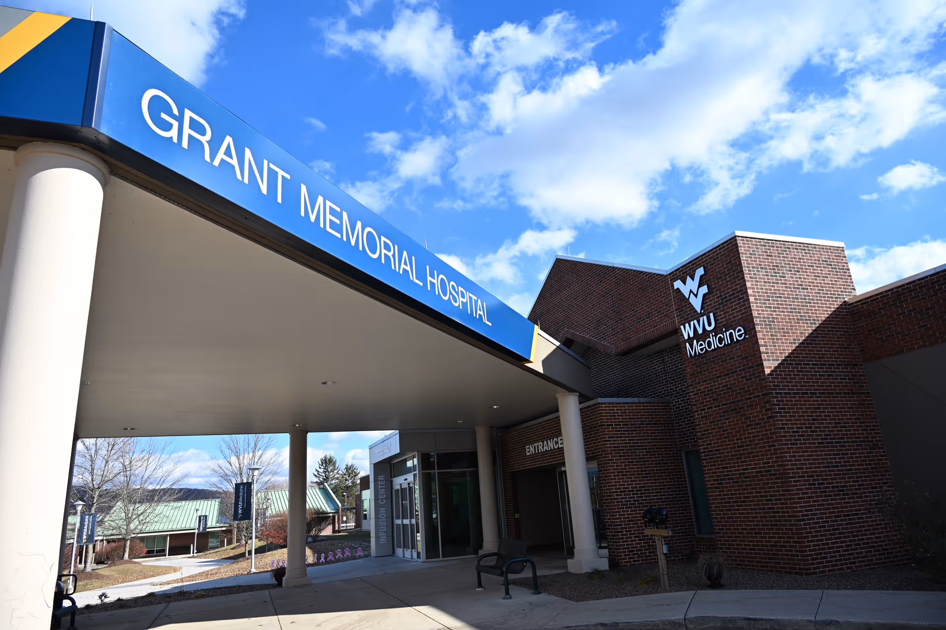 Exterior view of Grant Memorial Hospital entrance with blue sign and brick facade.